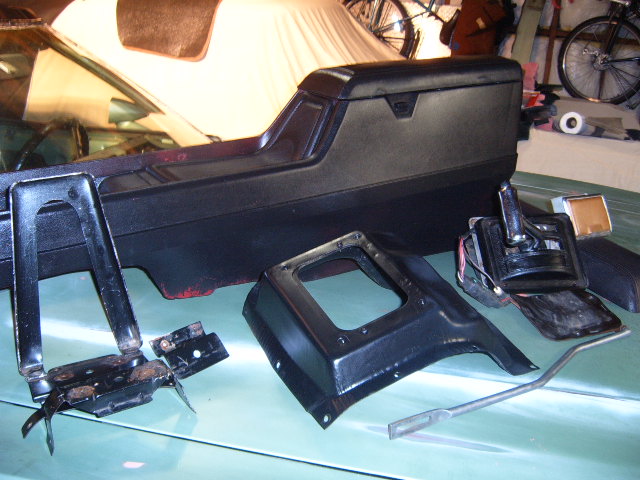 Disassembled car interior parts including a center console and shifter