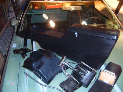 1973 Ford Ranchero - Car interior parts are laid out on the dashboard, ready for installation.