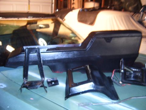 1973 Ford Ranchero - Disassembled car interior parts are spread out on a light green surface, possibly for repair or restoration.
