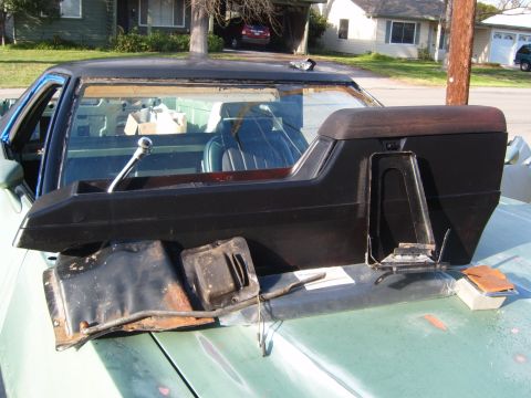1973 Ford Ranchero - Disassembled interior parts are laid out on the hood of a green Ford Ranchero.