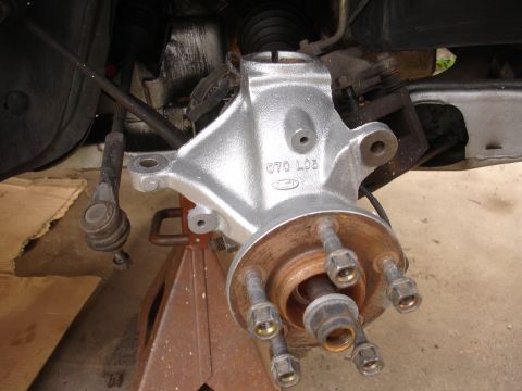 1995 Ford Taurus - A vehicle's suspension knuckle, likely a Ford part, is shown after being painted and before reassembly.