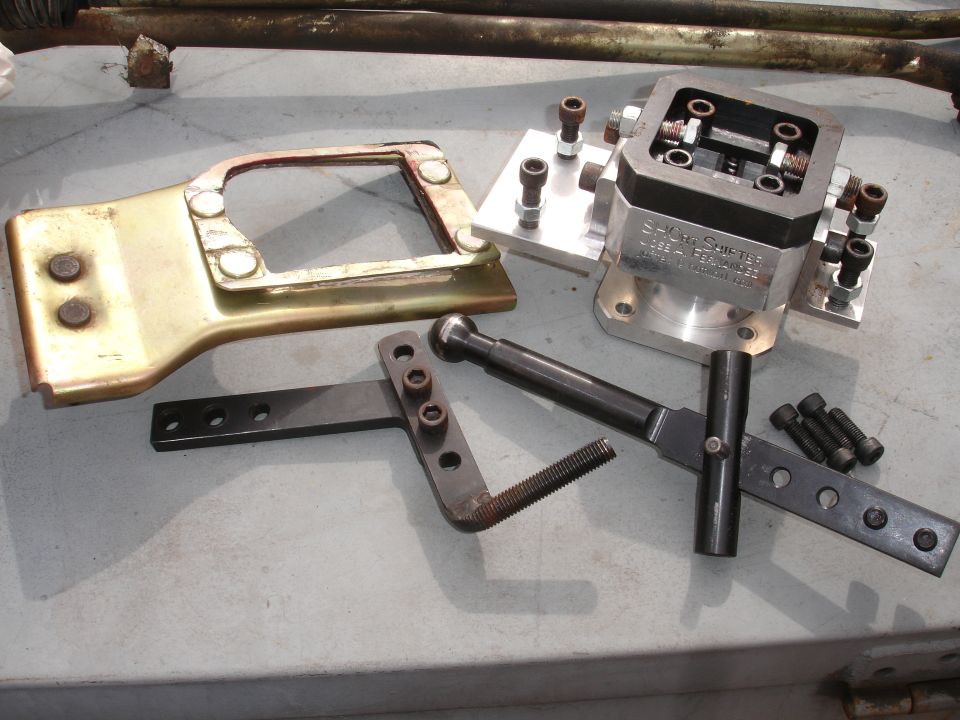 Short shifter assembly with metal bracket and hardware