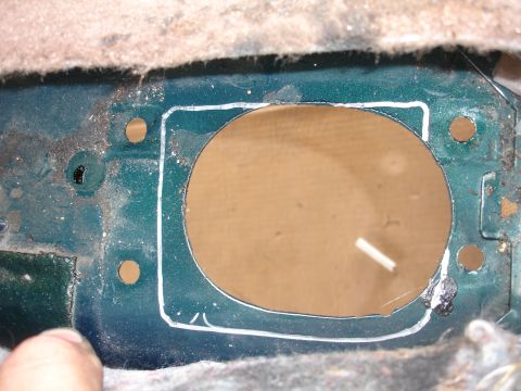 1995 Ford Taurus - A hole has been cut into the floor of a vehicle, revealing the underside.