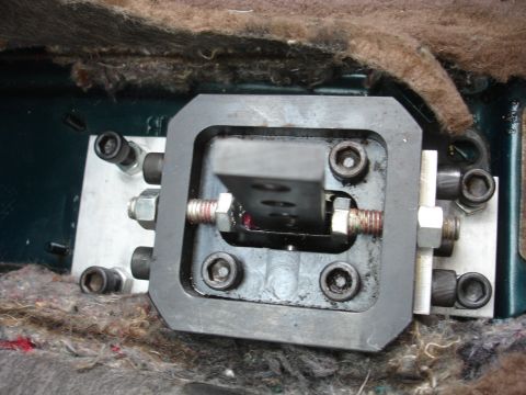 1995 Ford Taurus - Close-up view of an aftermarket short shifter mechanism installed in a vehicle.