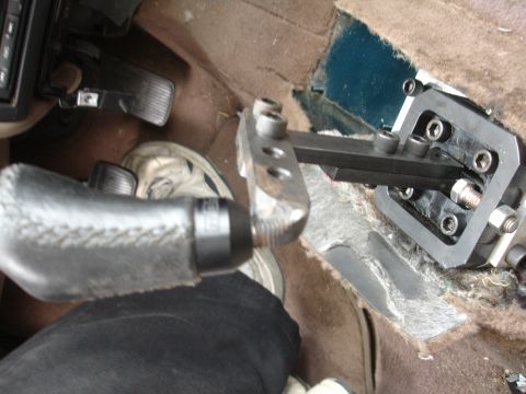 1995 Ford Taurus - Aftermarket short shifter mechanism installed in car interior, focusing on the shifter lever and linkage components.