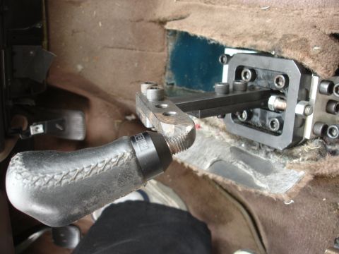 1995 Ford Taurus - Aftermarket short shifter assembly installed in a vehicle's center console area.