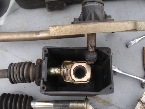 1995 Ford Taurus - Close-up view of a vehicle's shifter assembly, showing the linkage and protective boot.