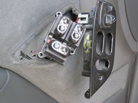 1993 Ford Bronco - Close-up of a disassembled car door control panel, revealing interior components and wiring.
