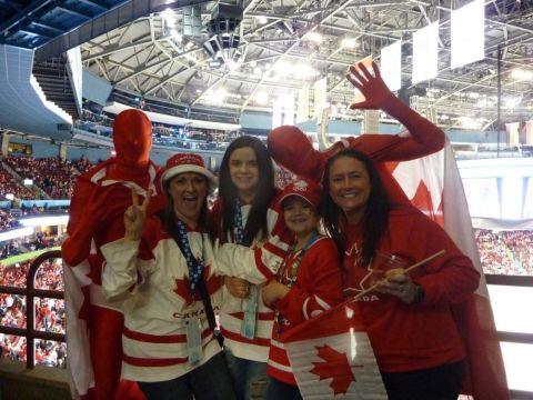 1996 Ford Bronco - Fans in Canadian Olympic attire celebrate in a stadium, holding flags and wearing team jerseys.