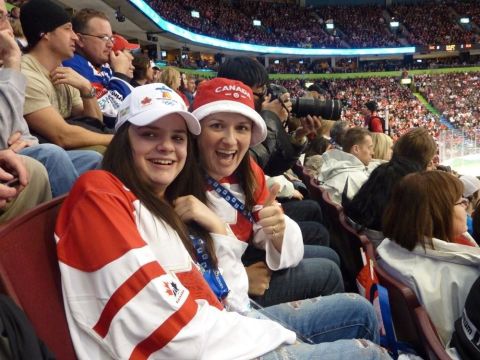 1996 Ford Bronco - Fans wearing Canadian team colors cheer at a packed arena during a competition.