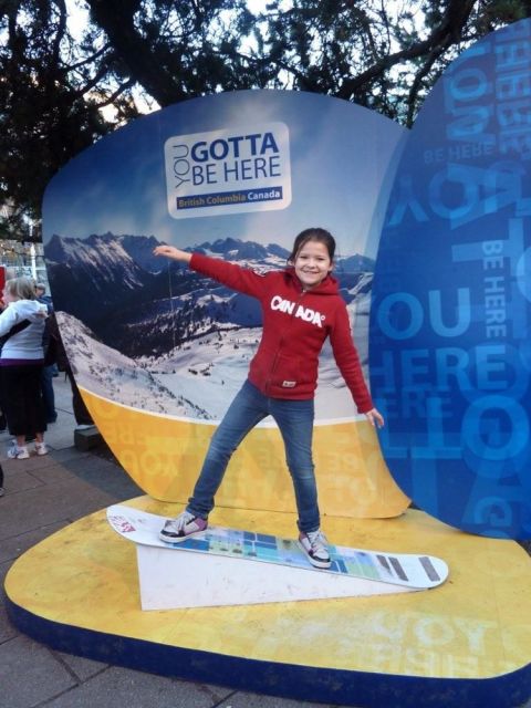 1996 Ford Bronco - A young girl poses on a snowboard in front of a "Gotta Be Here" British Columbia Canada promotional display.