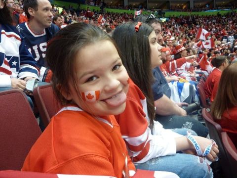1996 Ford Bronco - Spectators wearing Canadian team colors cheer at a sporting event.
