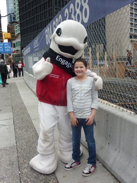 1996 Ford Bronco - A mascot and a child stand together on a sidewalk in front of a construction site.