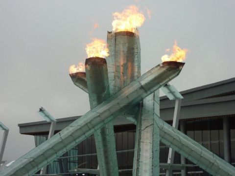 1996 Ford Bronco - The Olympic cauldron burns brightly, a symbol of the games against a backdrop of modern architecture.