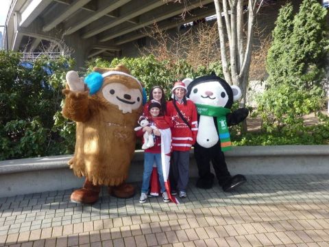 1996 Ford Bronco - People dressed in Canadian Olympic gear pose with mascots during an event.