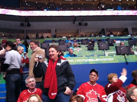 1996 Ford Bronco - Spectators in an arena, some wearing Canadian Olympic attire, watch an event.