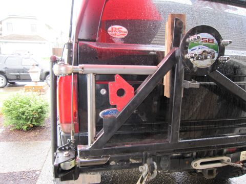 1996 Ford Bronco - The rear of a black Ford Bronco is shown with a custom bumper and spare tire mount, a Ford logo.