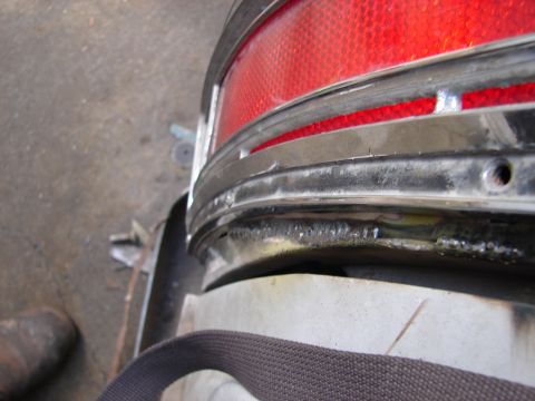1973 Ford Ranchero - Close-up of a 1973 Ford Ranchero's rear tail light assembly, showing chrome trim and the red lens.