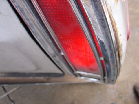 1973 Ford Ranchero - The rear tail light assembly shows signs of wear and the surrounding body panel has significant rust.