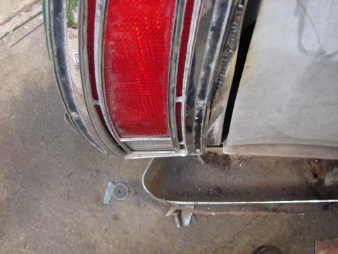 1973 Ford Ranchero - Close-up of a 1973 Ford Ranchero's rear tail light and surrounding chrome trim.