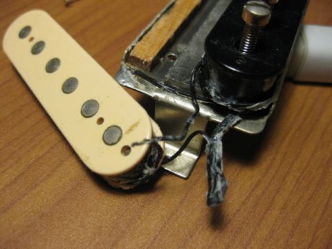 1989 Mazda MX-6 - Close-up view of a guitar pickup assembly, showing wiring and mounting hardware.