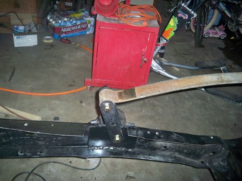 1985 Ford Bronco - Close-up of vehicle frame and suspension components with an orange hose nearby.