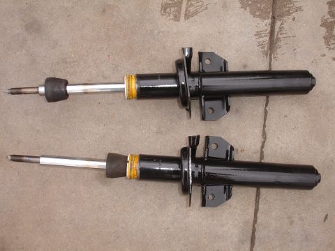 1995 Ford Taurus - A pair of automotive shock absorbers are shown, likely for replacement or sale.