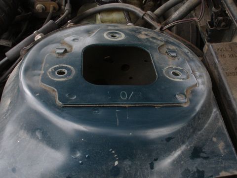 1995 Ford Taurus - This is a close-up view of a vehicle's strut tower, showing some stamped numbers and surrounding engine components.