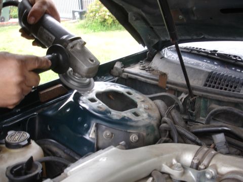 1995 Ford Taurus - Grinding down a car's strut tower with an angle grinder.