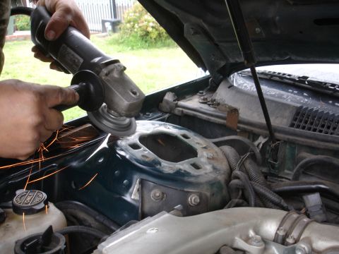 1995 Ford Taurus - Someone is using an angle grinder on a part of the car's engine bay.