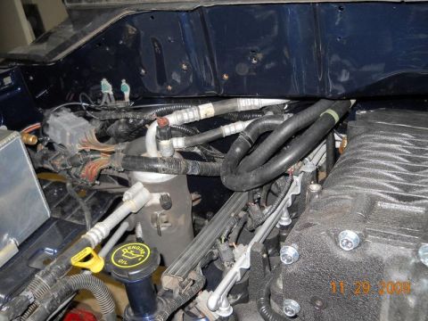 2007 Ford Mustang - Close-up view of an engine bay, a supercharger and various hoses and wiring. A date stamp indicates November 29, 2009.