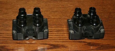 2007 Ford Mustang - A pair of ignition coils are displayed on a wooden background.