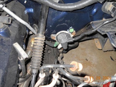 2007 Ford Mustang - A close-up view of various engine bay components, including hoses, wiring, and a sensor. The photo is dated November 29, 2009.