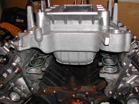 2007 Ford Mustang - Close-up view of an engine's intake manifold and cylinder heads, with some parts removed.