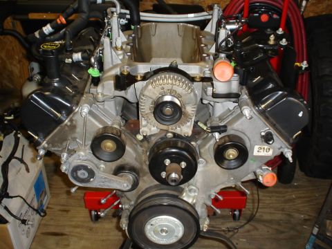2007 Ford Mustang - Engine assembly, likely from a Ford vehicle, is shown with various components including the alternator and drive pulleys.