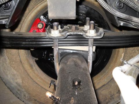 2007 Ford Mustang - Rear axle and leaf spring assembly with a red brake caliper visible.