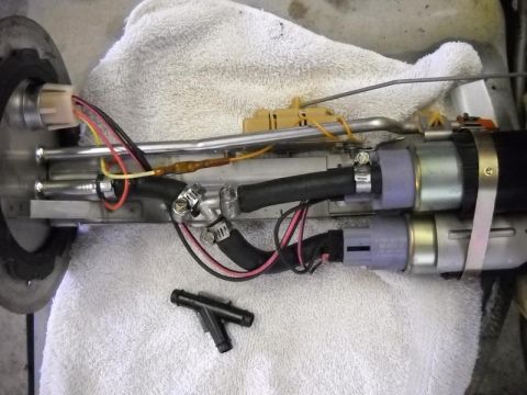 2007 Ford Mustang - A disassembled fuel pump assembly, showing its internal components and connections, is laid out on a white towel.