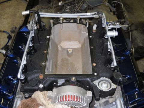 2007 Ford Mustang - Close-up view of an engine's intake manifold and alternator, likely during a repair or rebuild process.