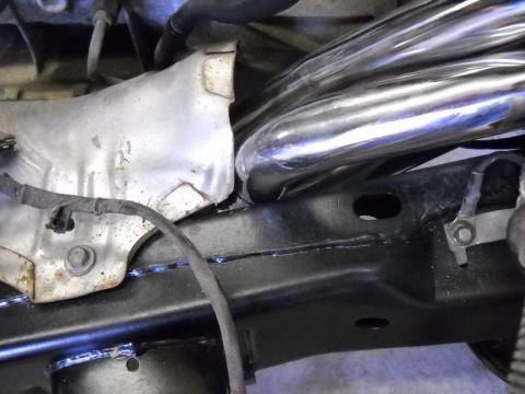 2007 Ford Mustang - Exhaust manifold pipes and heat shield visible on vehicle frame.