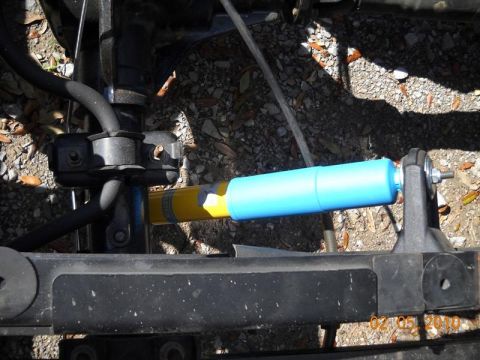 2007 Ford Mustang - Close-up view of a vehicle's suspension system, focusing on a shock absorber.