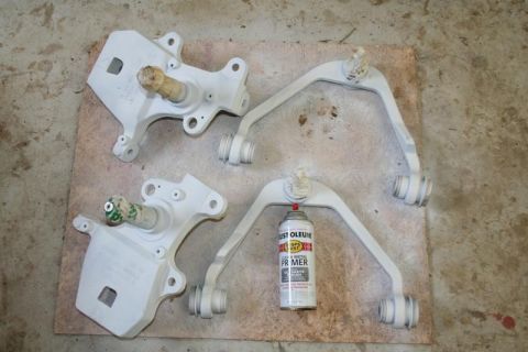 2007 Ford Mustang - Suspension parts painted white, alongside a can of primer.