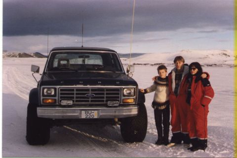 1986 Ford Bronco - Three people pose in front of a 1986 Ford Bronco in a snowy, outdoor setting.