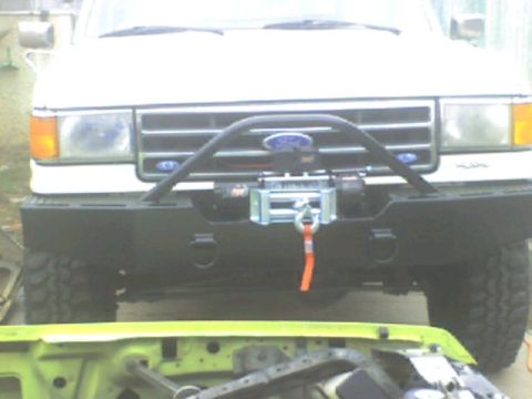 1989 Ford Bronco - Front view of a white 1989 Ford Bronco equipped with a winch.