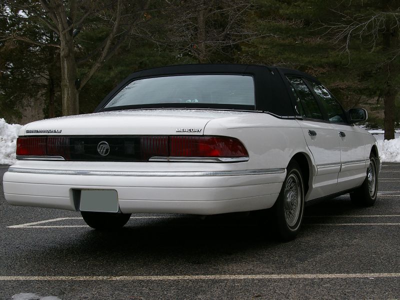 Rear view of a white 1994 Mercury Grand Marquis sedan with a black vinyl top