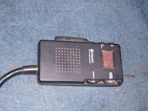 1979 Ford F-150 - A Clarion CB radio is shown lying on a blue carpeted surface.