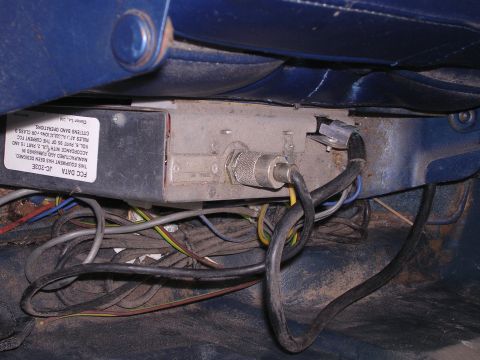 1979 Ford F-150 - A CB radio unit is installed beneath the vehicle seat, showing a label with FCC data.