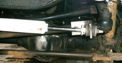 1979 Ford Bronco - Close-up view of the steering and suspension components on the underside of a vehicle.
