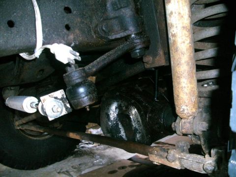 1979 Ford Bronco - Close-up view of the steering and suspension system components on the underside of a vehicle.