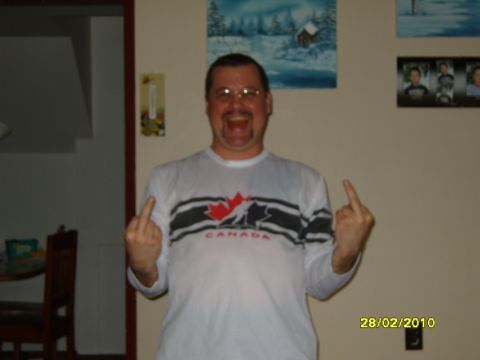 1989 Ford Bronco - A man wearing a long-sleeved shirt with Canadian imagery is shown giving the middle finger to the camera.