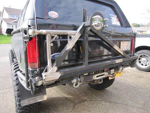 1996 Ford Bronco - Custom rear bumper and spare tire carrier installed on a black SUV.